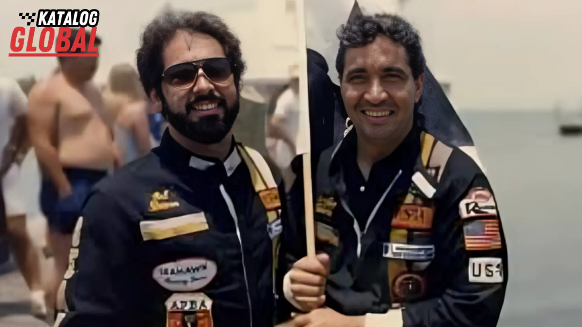 Two men smiling and dressed in racing suits adorned with various patches, symbolizing wealth and success, raising curiosity about "Willie Falcon Net Worth.