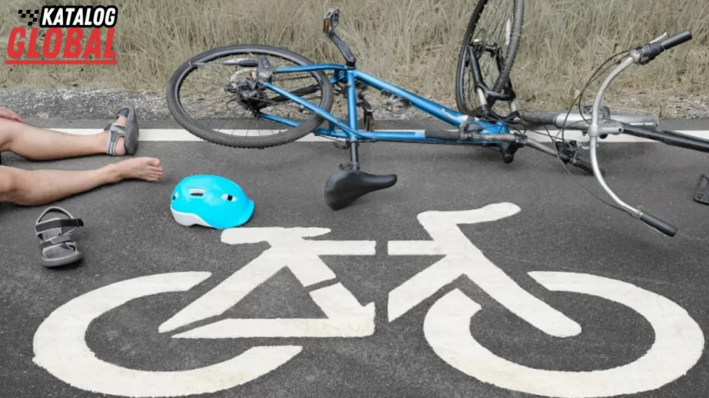 An image showing a cyclist on the ground next to a fallen bicycle and helmet on a bike lane, illustrating the question, "Can You Get a DUI on a Bike?" with a focus on surprising legal implications of biking under the influence.