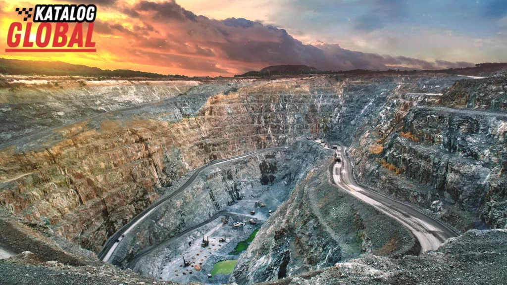 A vast open-pit mine with winding roads and trucks driving deep into the excavation. Can you have your own mining company? Uncover the scale of operations required.